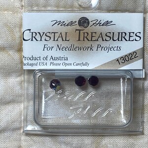May include: A small plastic package containing three red crystal rhinestones for needlework projects. The package is labeled "Mile Hill Crystal Treasures" and "Product of Austria".