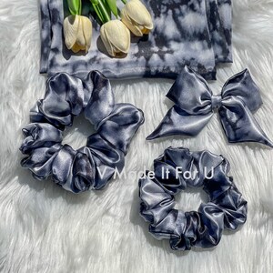 May include: Three gray satin scrunchies, one large and two small, with a gray and white tie-dye pattern. A gray satin bow with a tie-dye pattern is also included. The text "V Made It For U" is visible in the image.