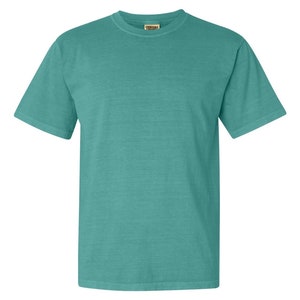 May include: A teal blue short-sleeved t-shirt with a Comfort Colors tag on the front.