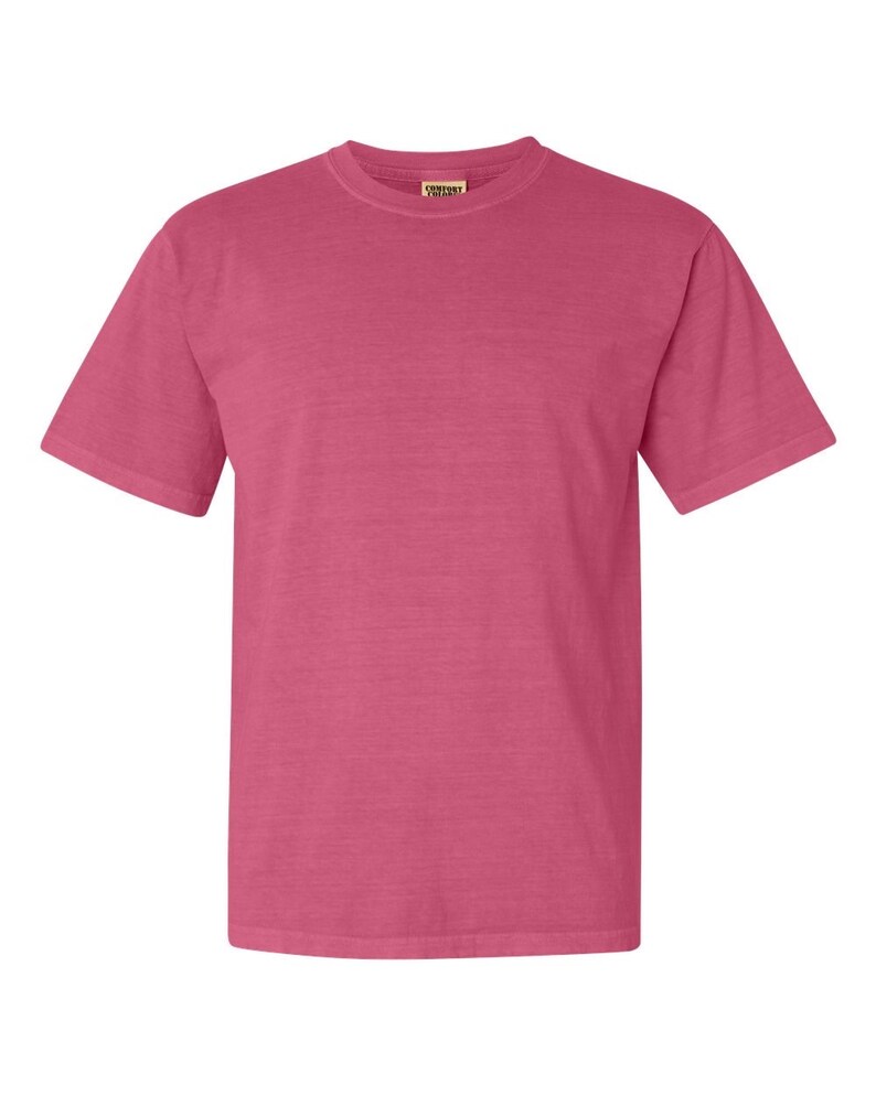 May include: A solid pink short-sleeved t-shirt with a Comfort Colors tag on the front.