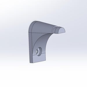 May include: A gray plastic wall mount with a curved design and a rounded end. The mount has a hole for a screw.