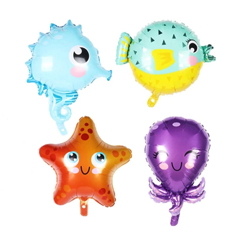 May include: Four colorful foil balloons shaped like a starfish, a seahorse, a pufferfish, and an octopus. Each balloon has a cartoon face with eyes, a mouth, and rosy cheeks.