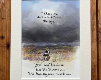 May include: A framed watercolour print depicting a horse and fox in a field beneath a stormy sky. The artwork includes handwritten text: "Those are dark clouds," said the boy. "Yes," said the horse, "but they'll move on... The blue sky above never leaves."