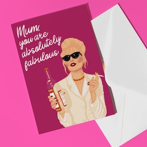 May include: A pink card with a white envelope. The card features a cartoon illustration of a woman with blonde hair, sunglasses, and a cigarette in her hand. The text on the card reads "Mum, you are absolutely fabulous."