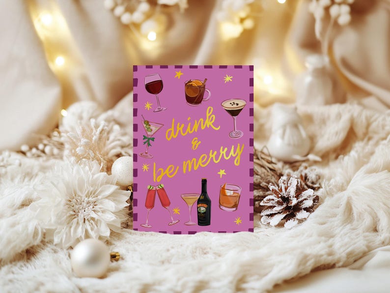 May include: A greeting card with a purple background and the words "drink & be merry" in yellow script. The card features illustrations of various cocktails and drinks, including wine, martinis, and a bottle of liqueur.