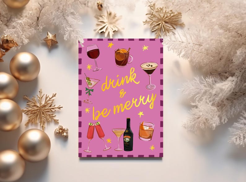 May include: A pink greeting card with the words "drink & be merry" in gold script, surrounded by illustrations of cocktails and drinks. The card is decorated with gold stars and a border. Festive holiday theme.