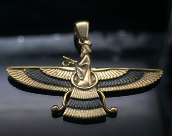 May include: A gold-colored pendant in the shape of a winged creature with black accents. The pendant is a stylized representation of a mythical bird.