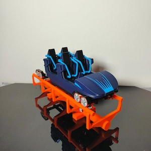 May include: A set of three ceramic mugs with a speckled, matte finish. The mugs are in shades of cream, light gray, and dark gray. Each mug has a simple, minimalist design and a rounded handle.