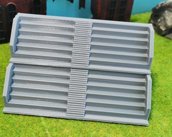 May include: A set of two gray plastic stairs with a textured surface. The stairs are stacked on top of each other.