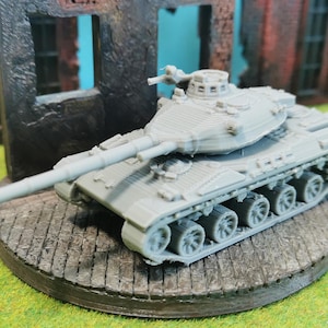 May include: A grey plastic model of a tank with a long barrel and a turret. The tank is sitting on a grey wooden base.
