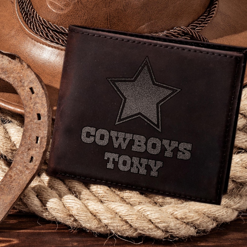 May include: A brown leather wallet with a black star and the words "COWBOYS TONY" embossed on the front.