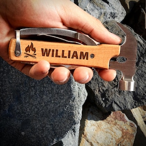May include: A personalized wooden multi-tool with a hammer, knife, and bottle opener. The tool is engraved with the name "WILLIAM" and a campfire design.