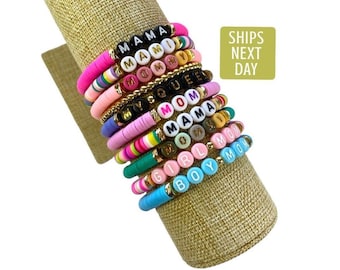 May include: A stack of colorful beaded bracelets with different words spelled out on them, including "Mama", "Mommy", "Queen", "Girl Mom", and "Boy Mom".