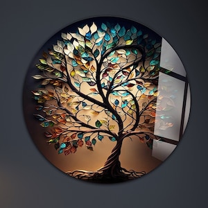 Puede incluir: Una pieza de arte de pared redonda con un árbol abstracto colorido sobre un fondo marrón. El árbol tiene una variedad de hojas azules, verdes, amarillas y naranjas.