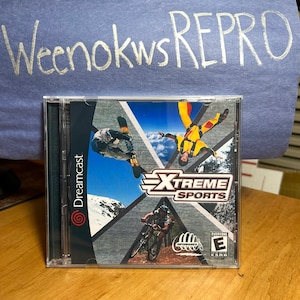 May include: A Dreamcast game case with a blue, white, and green background. The game title is "Xtreme Sports" and the ESRB rating is "Everyone".