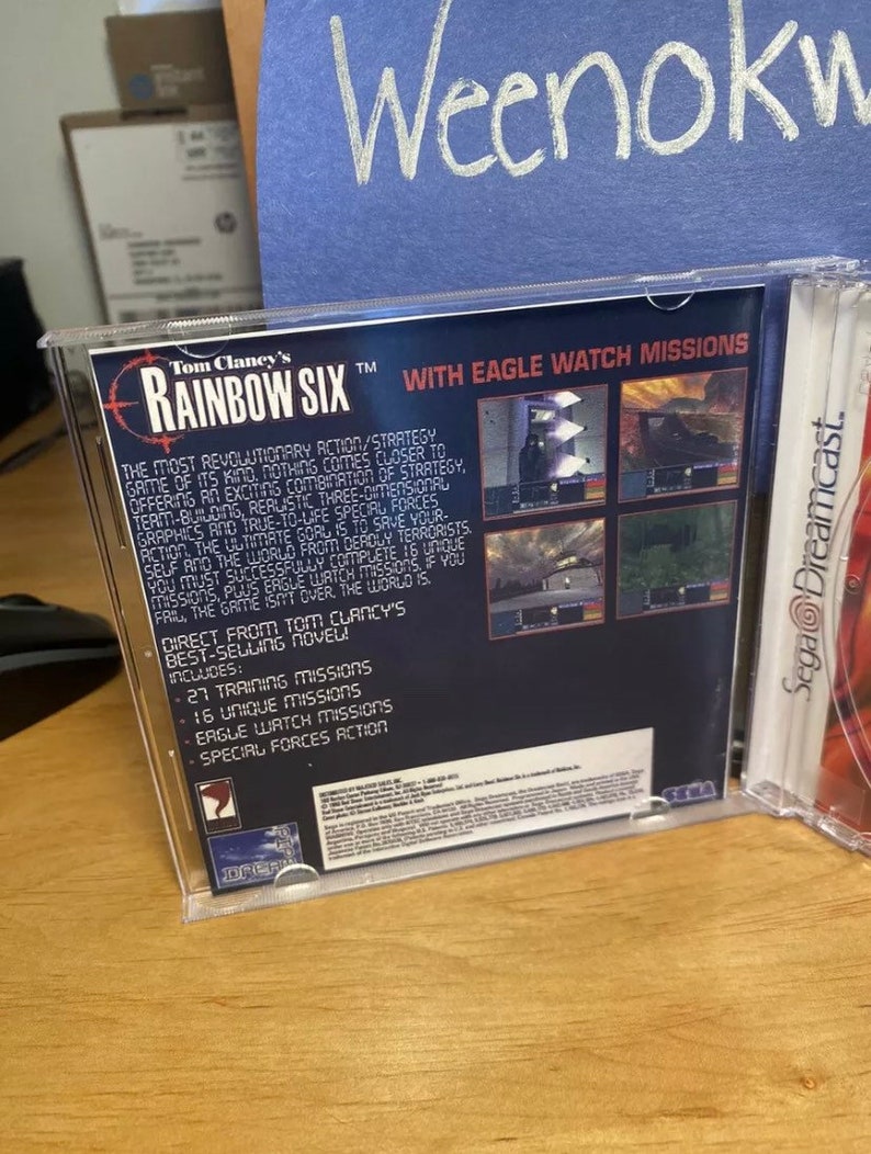 May include: A Sega Dreamcast game case for Tom Clancy's Rainbow Six, featuring a black and white image of a soldier holding a gun. The back of the case includes a description of the game, including the text "With Eagle Watch Missions".