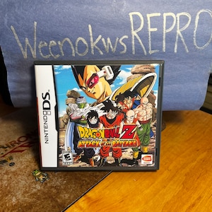 May include: A Nintendo DS game cartridge for Dragon Ball Z: Attack of the Saiyans. The game features a colorful illustration of characters from the anime series, including Goku, Vegeta, and Gohan.