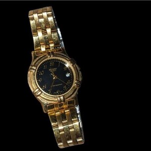 May include: Gold-toned SEARS QUARTZ wristwatch with a black dial. The watch features a gold-colored band and a round face with gold-colored hands and numerals. The watch is water resistant.
