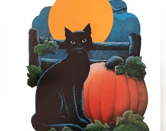 May include: A Halloween-themed decoration featuring a black cat, a large orange pumpkin, and a full moon. The cat is sitting in front of the pumpkin, with a wooden fence and foliage in the background. The moon is a bright orange circle.