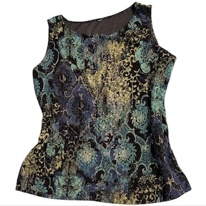 May include: Sleeveless top with a black, teal, and blue floral pattern. The fabric has a textured appearance with gold accents. The top has a scoop neckline and a slightly flared hemline.