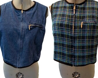 May include: Two sleeveless vests displayed on dress forms. One is denim blue with a black trim and a gold zipper. The other is a plaid pattern in shades of blue, green, and black, also with a black trim and gold zipper.