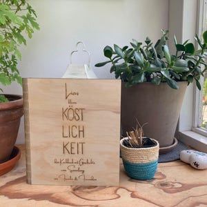 May include: A wooden sign with the text "Lieb  blume  kostlich  keit  der  Kallbach  at  Gedichte  eine  Sammlung  -  Familie  &  Freunde" engraved on it.