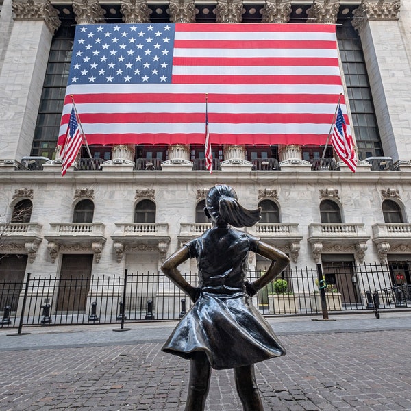 Fearless Girl in front of the New York Stock Exchange (NYSE) with Stars and Stripes