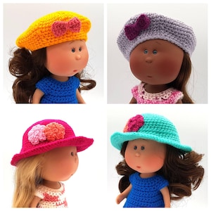 May include: Four dolls wearing different crocheted hats. The hats are yellow, purple, pink, and turquoise. Each doll has brown hair and is wearing a different coloured dress.