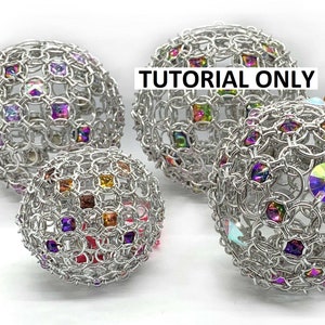 May include: Four silver chainmail spheres with colourful iridescent crystals embedded in the chainmail. The spheres are of varying sizes and are arranged on a white surface. The text "TUTORIAL ONLY" is superimposed on the image.