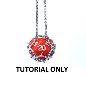 May include: A red twenty-sided die is encased in a silver wire cage and hangs from a silver chain. The die has white numbers on it. The image is labeled "TUTORIAL ONLY".