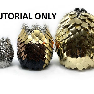 May include: Three different sized chainmail bags, one silver, one gold and copper, and one gold. The bags are all round and have a drawstring closure. The image is labeled "TUTORIAL ONLY".