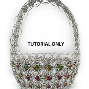 May include: A silver metal basket with a handle, woven in a chainmail pattern. The basket is decorated with iridescent green, red, and purple beads.