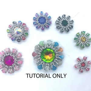 May include: A collection of eight silver-toned flower-shaped jewellery pieces with different coloured crystals in the centre. The crystals are surrounded by smaller beads in various colours. The text "TUTORIAL ONLY" is printed below the jewellery pieces.