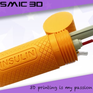 May include: A bright orange 3D printed case with a textured surface and the word "INSULIN" printed on it. The case is open and contains a pen and other medical supplies.