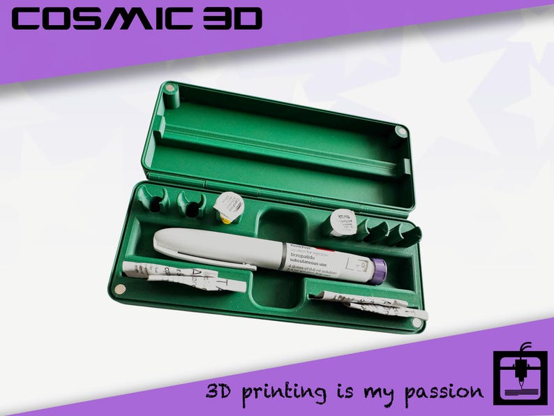 May include: Green plastic case containing a white and gray medical pen, small vials, and paper inserts. The case is open, revealing the contents. Text at the top reads "COSMIC 3D" and at the bottom "3D printing is my passion".