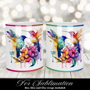 May include: Two white ceramic mugs with a colorful watercolor design of two hummingbirds and a flower. The mugs have a red and green rim.