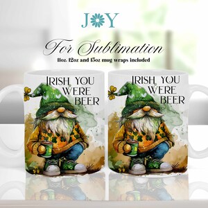 May include: Two white ceramic mugs with a green, yellow, and brown gnome design. The mugs have a handle on the right side and the text "Irish You Were Beer" is printed on the front of each mug.