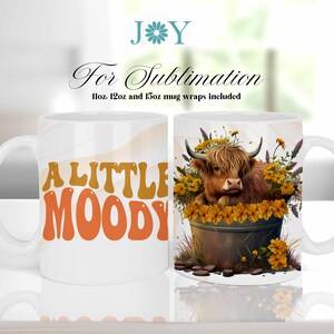 May include: White ceramic mug with a design of a Highland cow in a pot of yellow flowers. The text "A LITTLE MOODY" is on the other side of the mug.