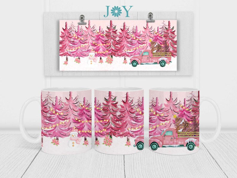 May include: A white ceramic mug with a pink and white Christmas tree design. The mug features a pink truck carrying a Christmas tree and a snowman in the snow.