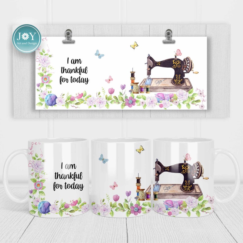 May include: White ceramic mug with a floral design and the text "I am thankful for today". The mug features a vintage sewing machine with spools of thread and a pair of scissors.