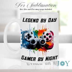 May include: White ceramic mug featuring a colourful gamer controller graphic and the text "LEGEND BY DAY GAMER BY NIGHT".