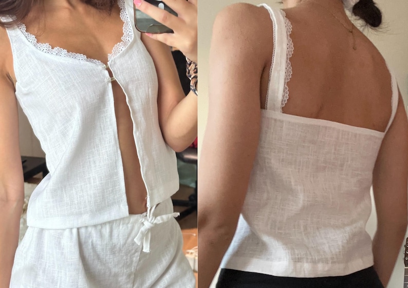 May include: White linen tank top with a lace trim and a button down front. The tank top is paired with matching linen shorts.