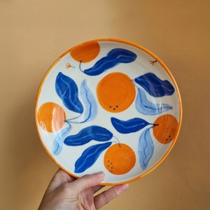 Ceramic bowl with orange, blue and orange pattern, handcrafted.