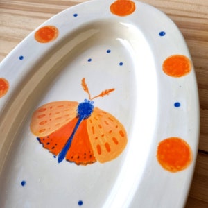 Ceramic insect bowl "Plume", orange, sky blue and ultramarine blue graphic butterfly, unique piece