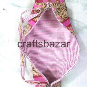 May include: Pink and tan patterned tote bag with a striped interior. The bag has a zipper closure and a shoulder strap. The text "craftsbazar" is visible on the bag.