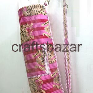 May include: Pink and red yoga mat bag with a striped pattern and a tiger print design. The bag has a zipper closure and a shoulder strap. The text "craftsbazar" is printed on the bag.
