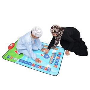 On this image two children are using the Interactive Kids prayer mat.