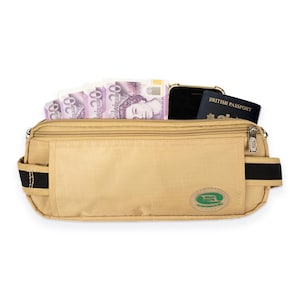 May include: A beige travel money belt with a zipped main compartment. The belt is filled with twenty-pound notes, a black smartphone, and a British passport. It has black elastic straps and a green and white logo.