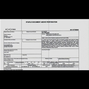 May include: A black and white American Airlines Air Waybill document featuring printed text fields for shipper and consignee information, routing details, and carrier terms. The form includes specific data for a shipment from UVF to ORF.