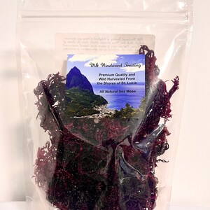 May include: A clear resealable plastic pouch containing dark purple dried sea moss. A label features the text M&G Windward Trading, Premium Quality and Wild Harvested From the Shores of St. Lucia, All Natural Sea Moss, and a landscape image.